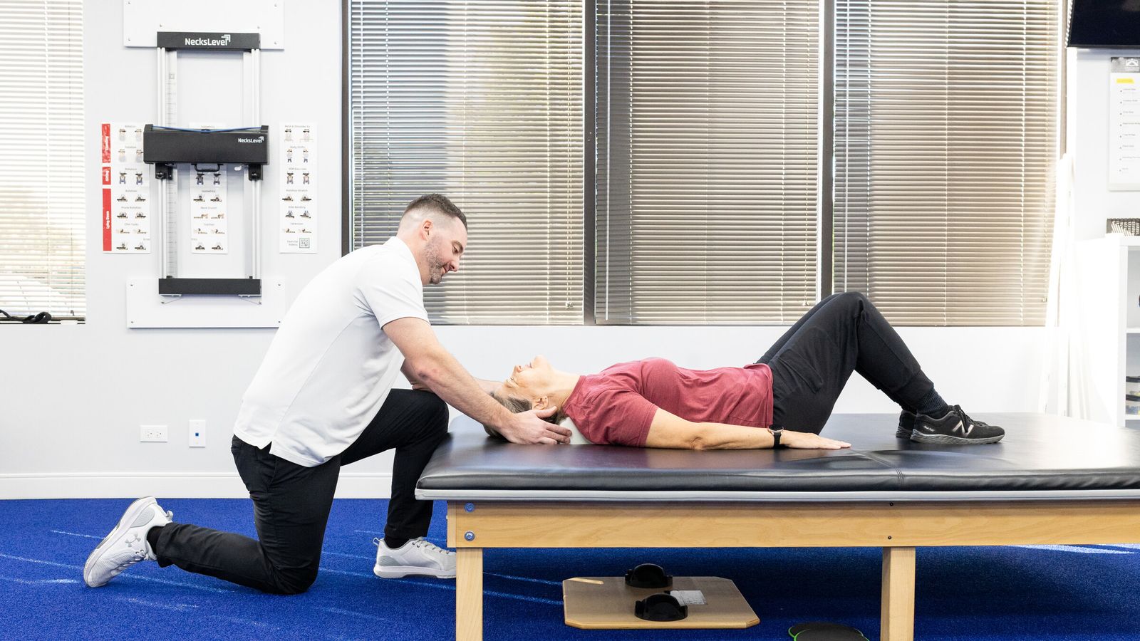 Chiropractor cradles a patient's head during a gentle cervical treatment