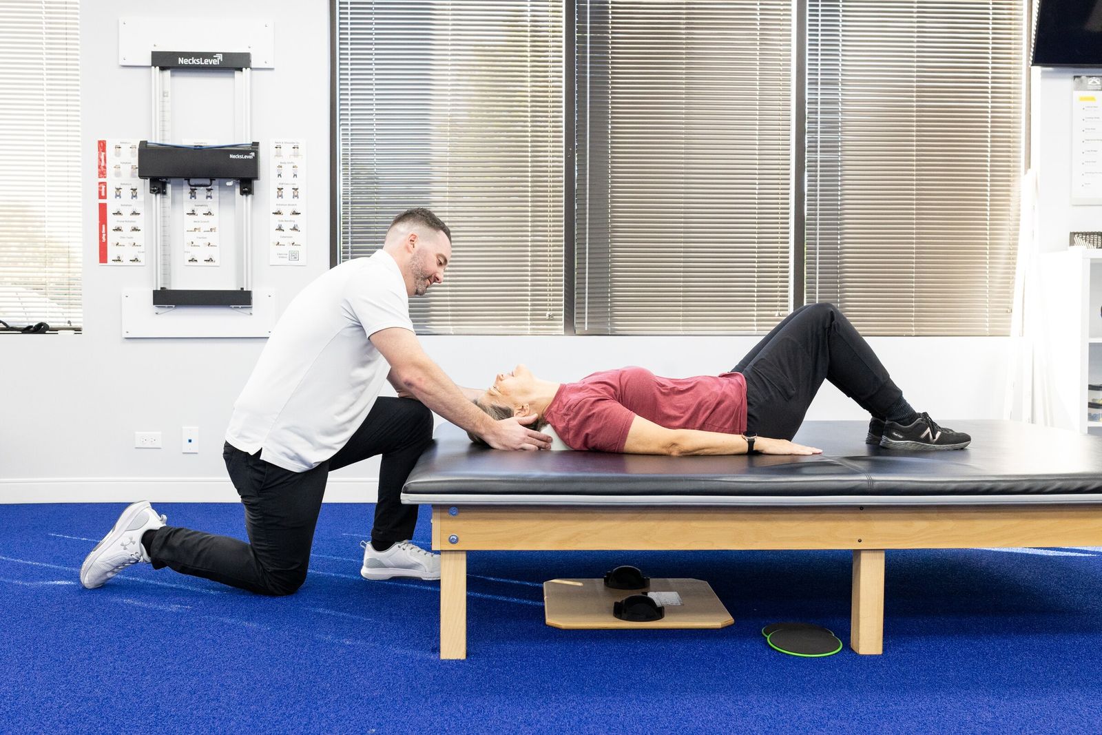 Chiropractor cradles a patient's head during a gentle cervical treatment